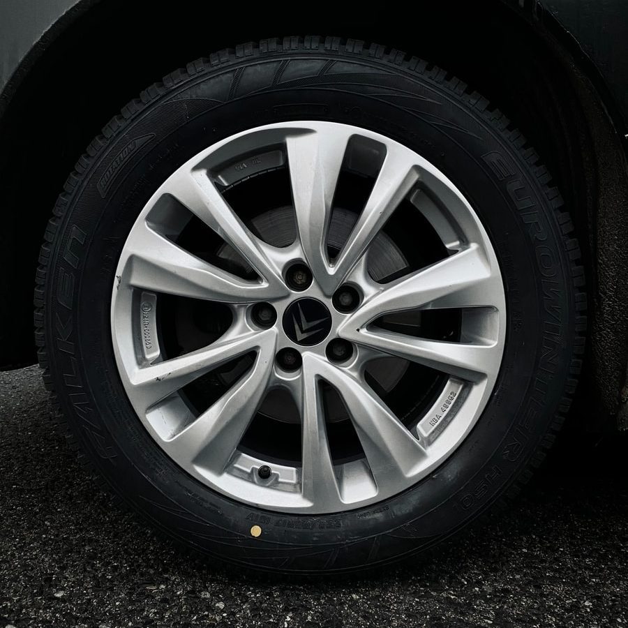 silver 5 spoke wheel with tire